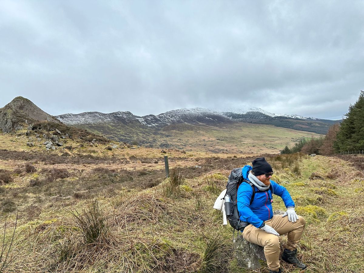A messy desk with notebooks, a laptop, and sketches of app screens